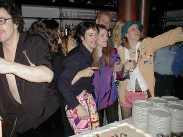 Cast and cake at the opening party.